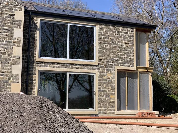 floor to ceiling glazing on stone new build home in Bolton