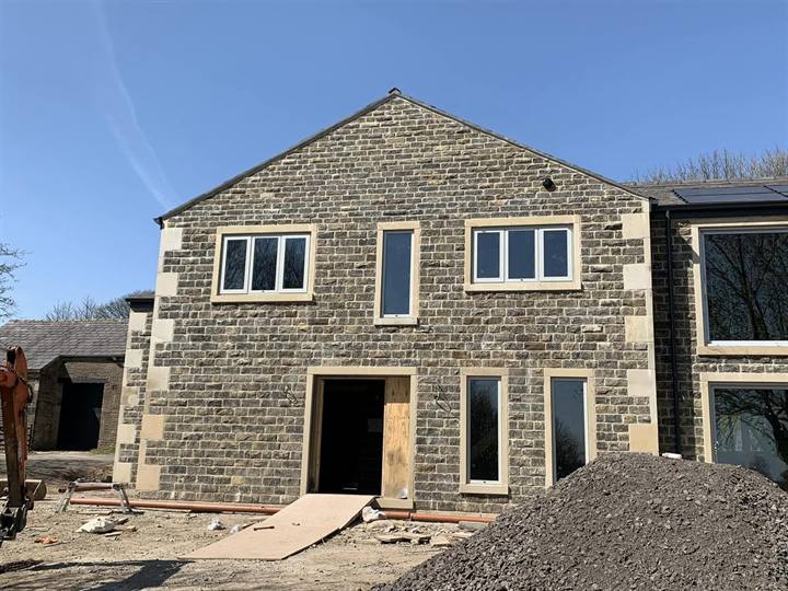 stone elevation of new build house in Bolton